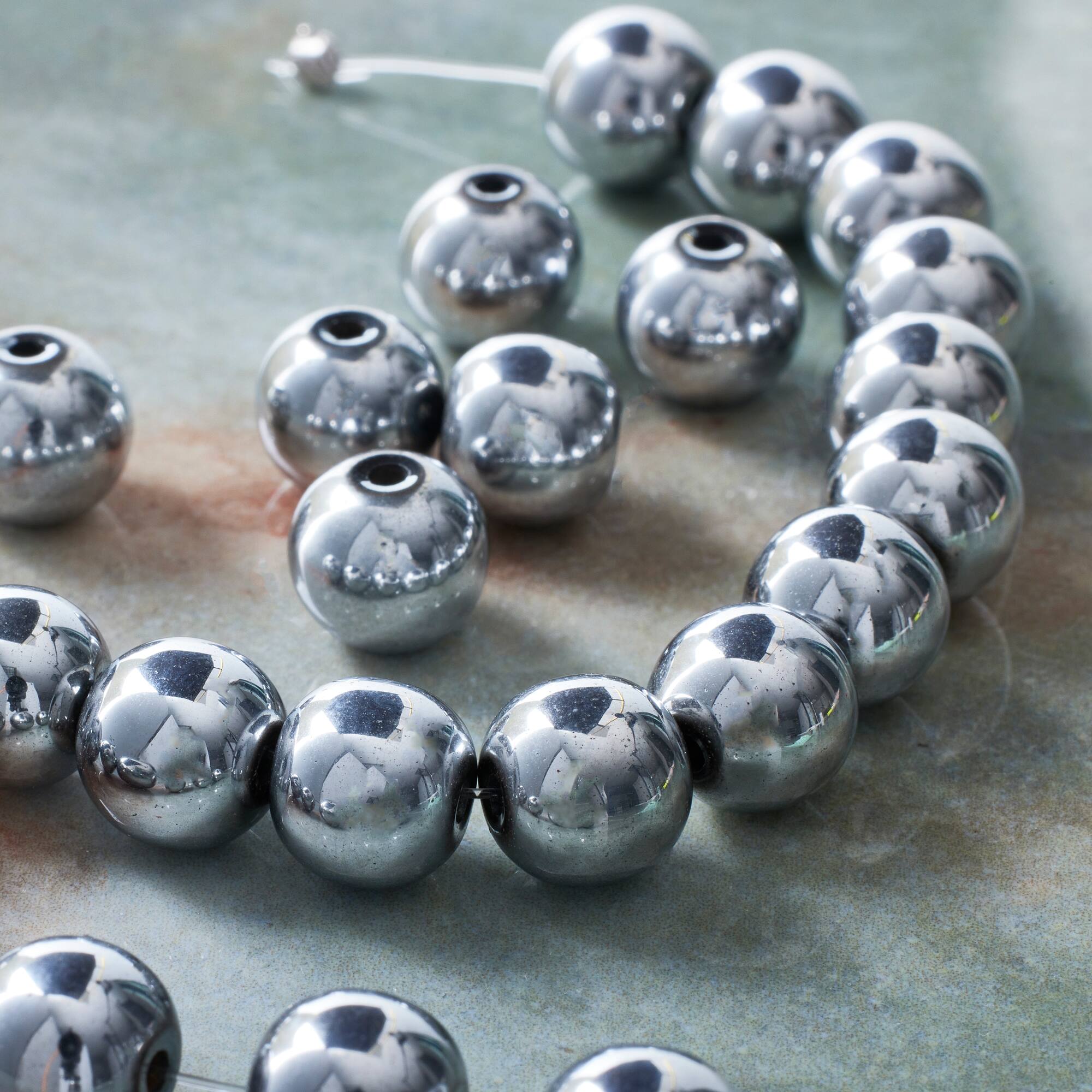 9 Packs: 24 ct. (216 total) Silver Hematite Round Beads, 10mm by Bead Landing™